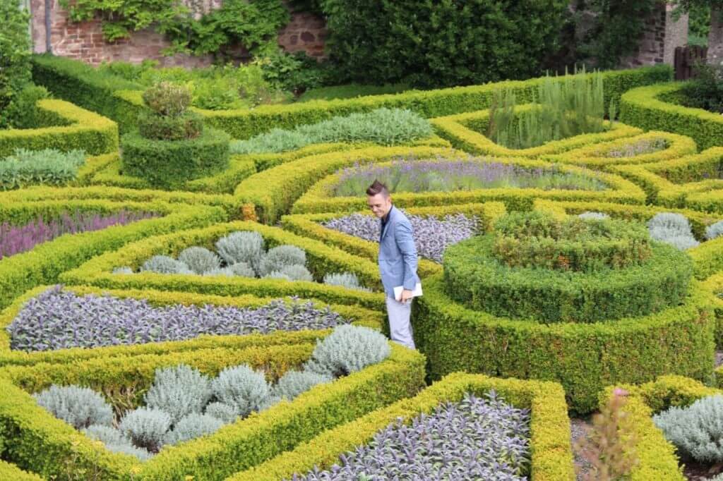 Garden Ninja in a topiary maze looking at Plant specimens