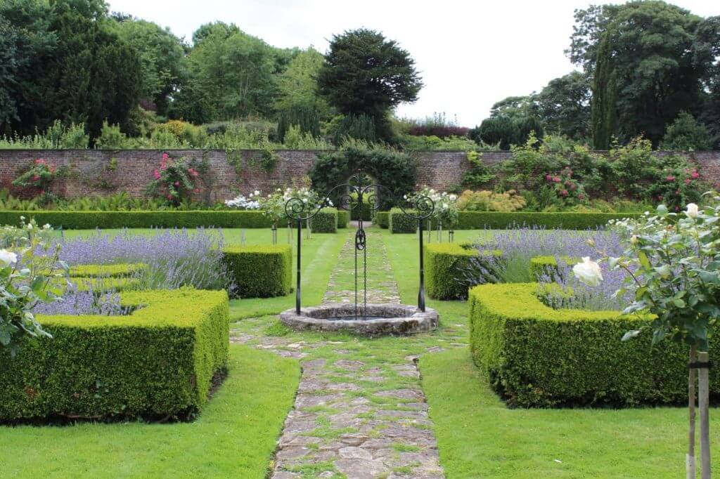 A formal landscaped garden with hedges