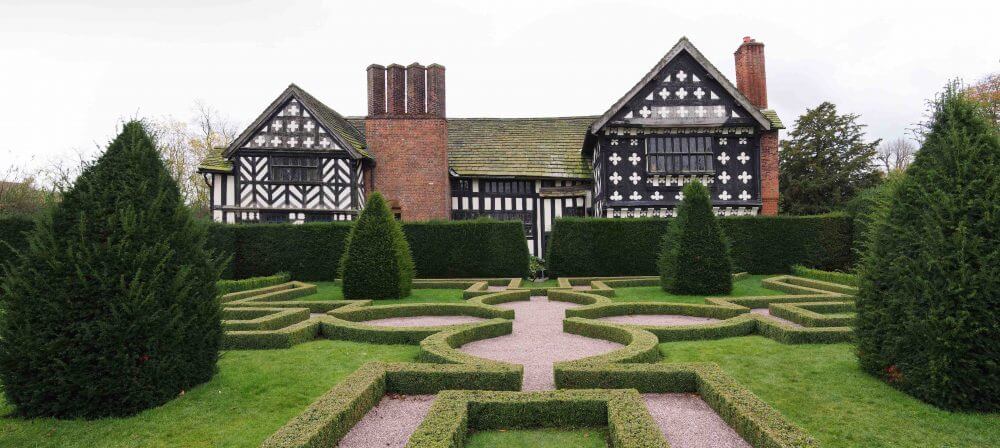 A knot garden next to a Tudor mansion at Little Moreton Hall