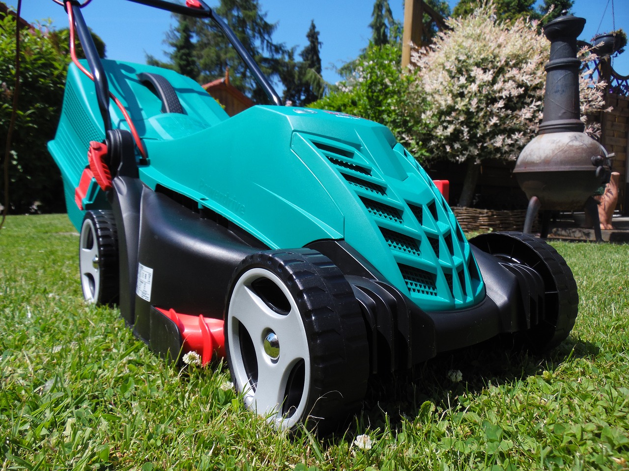 Electric corded lawn mower on a garden lawn