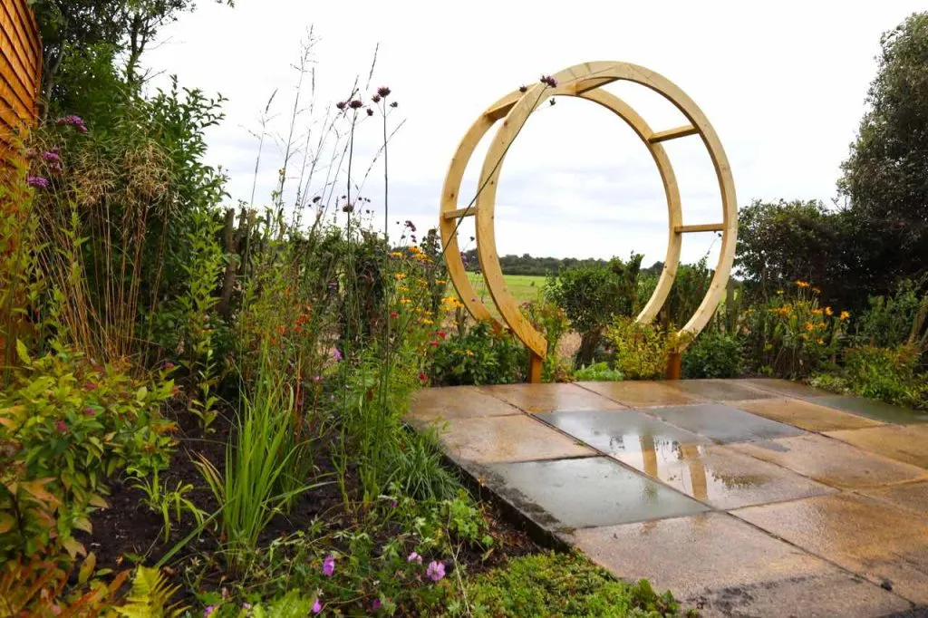 A moon gate and borrowed view in a garden