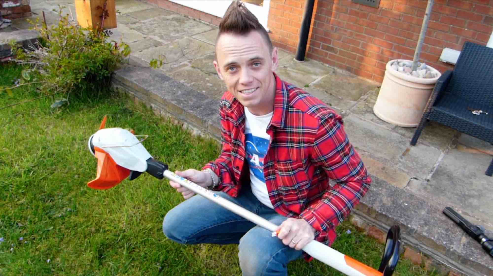 Garden Ninja using a powered strimmer on a garden meadow