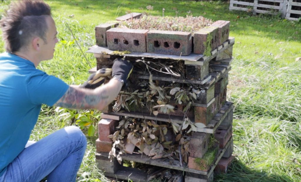 Garden Ninja filling a bug hotel