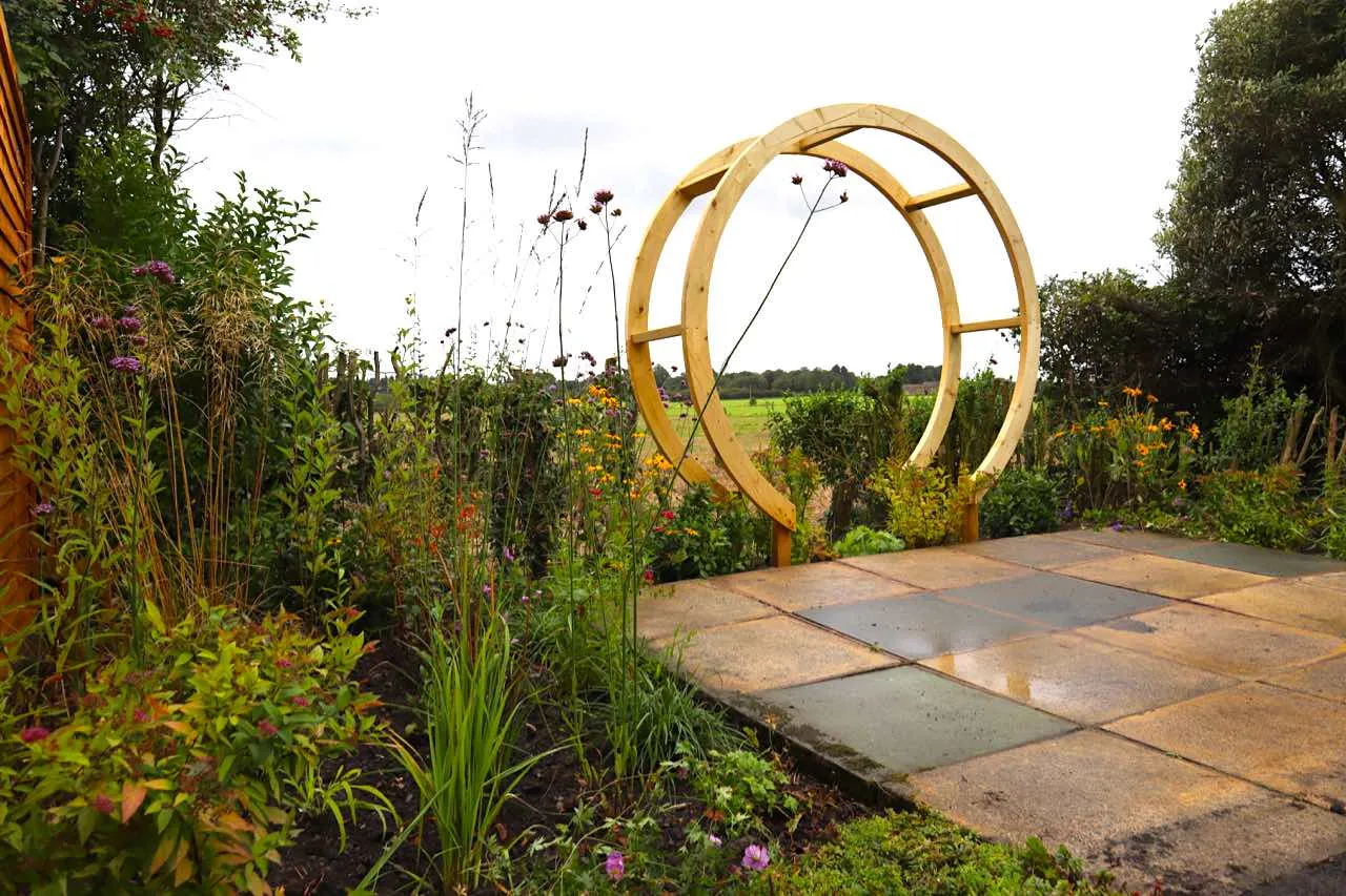 A moongate looking through to a field