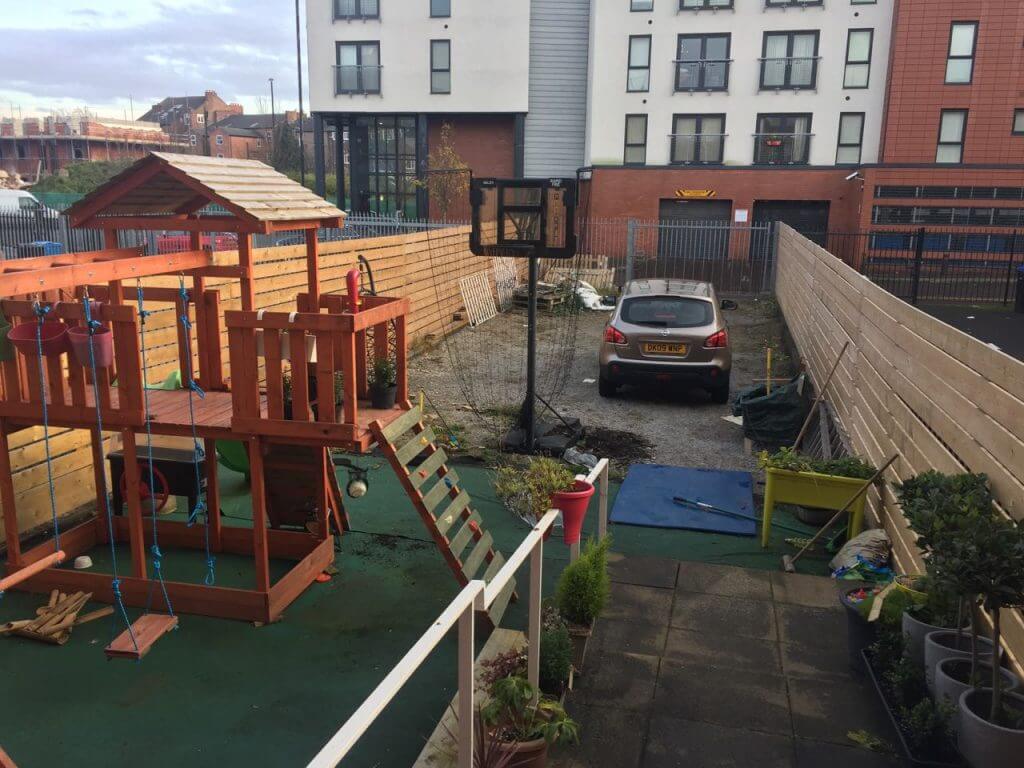 A derelict back garden with play equipment
