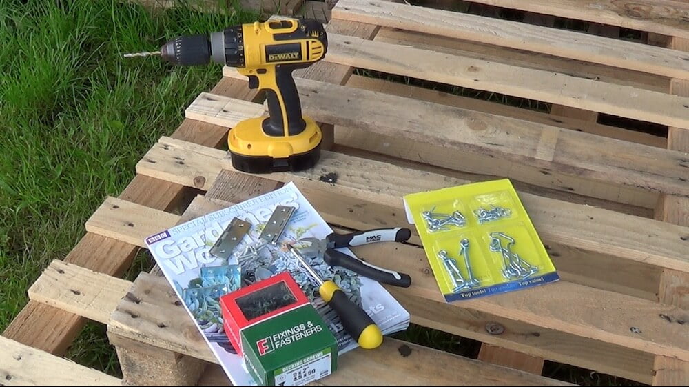 A drill, copy of gardeners world and a pallet