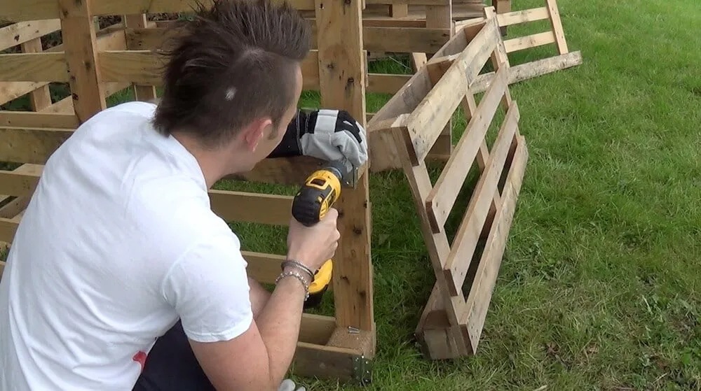 Garden Ninja screwing together compost bins