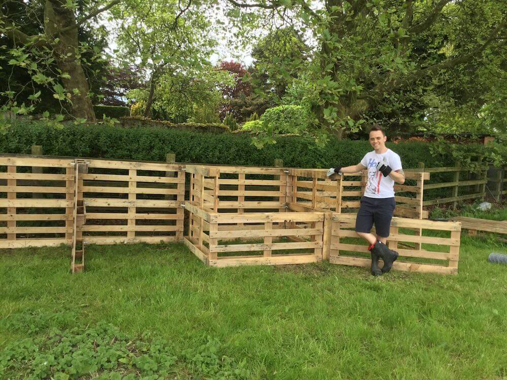 Garden Ninja stood next to three home made compost bins