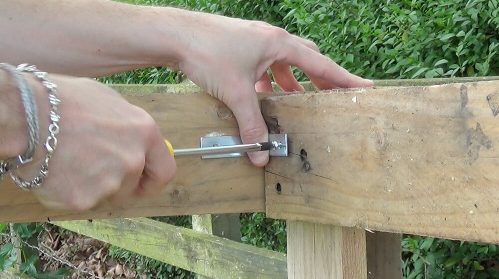 Screwing in brackets on a compost bin