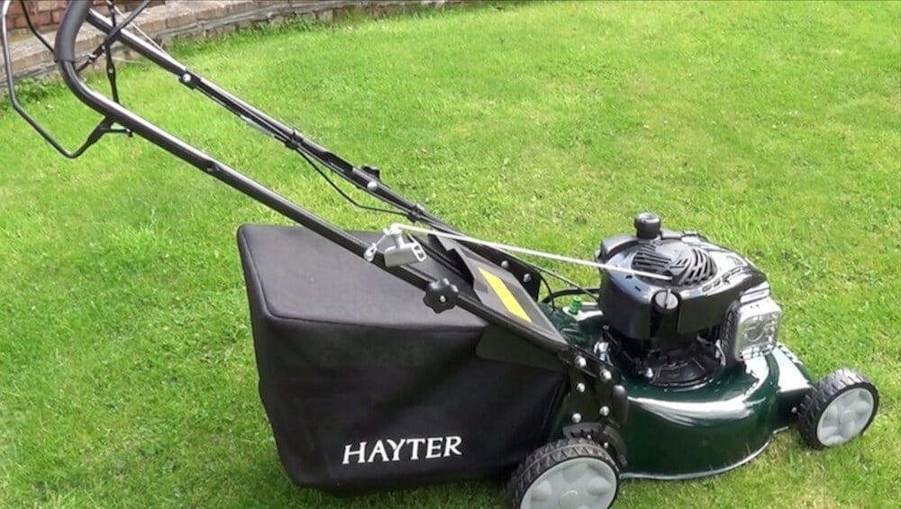 A Hayter petrol lawn mower on a lawn