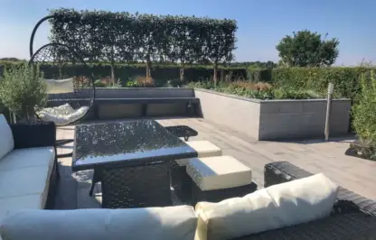 Outdoor living social garden with a white sofa by Garden Ninja