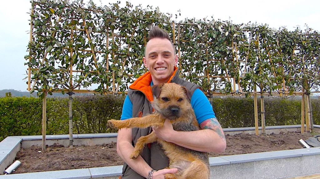 Garden Blogger Lee Burkhill holding his dog barry