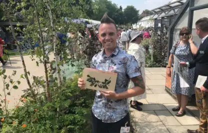 Garden Ninja holding his Chelsea Award