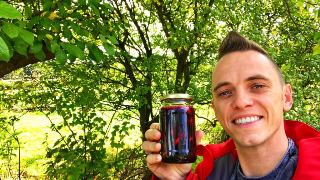 Lee Burkhill holding a jar of homemade damson jam
