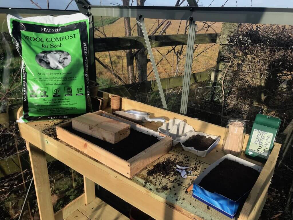 A potting bench with wooden seed trays
