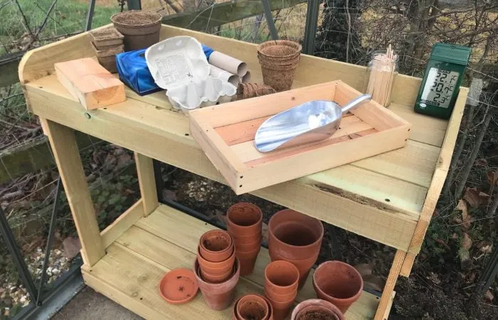 A wooden seed bench full of pots garden ninja