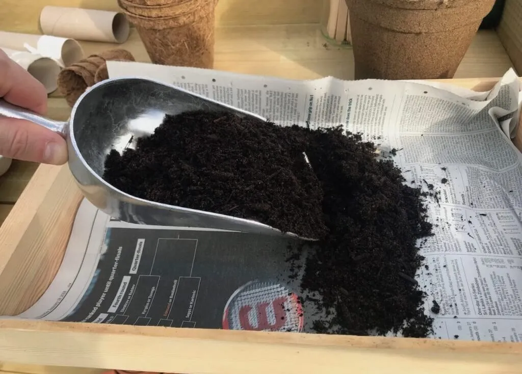 Garden Ninja filling a seed tray with compost