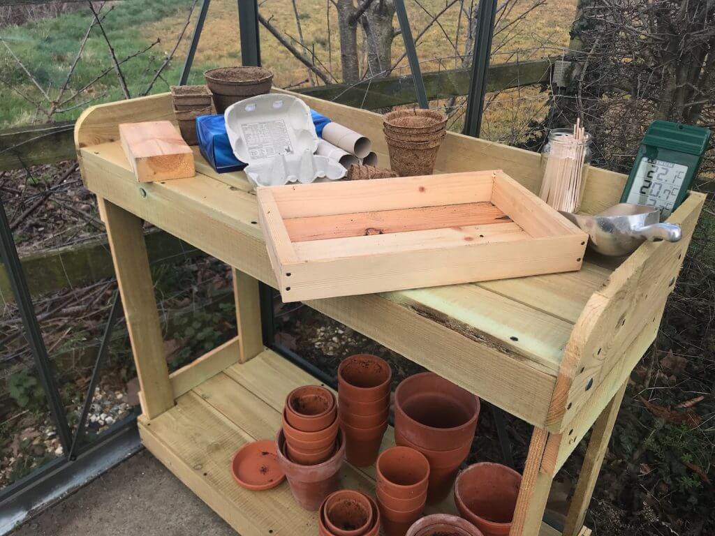 A wooden potting bench and garden ninja