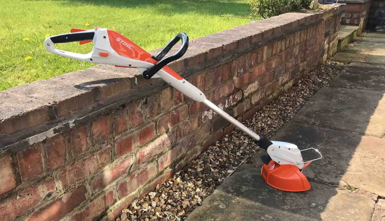 A Stihl strimmer against a wall