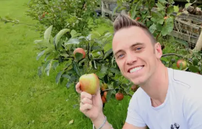 Garden Ninja smiling holding an apple