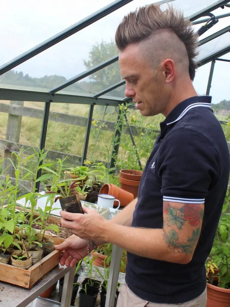 Garden Ninja holding a plastic free seedling