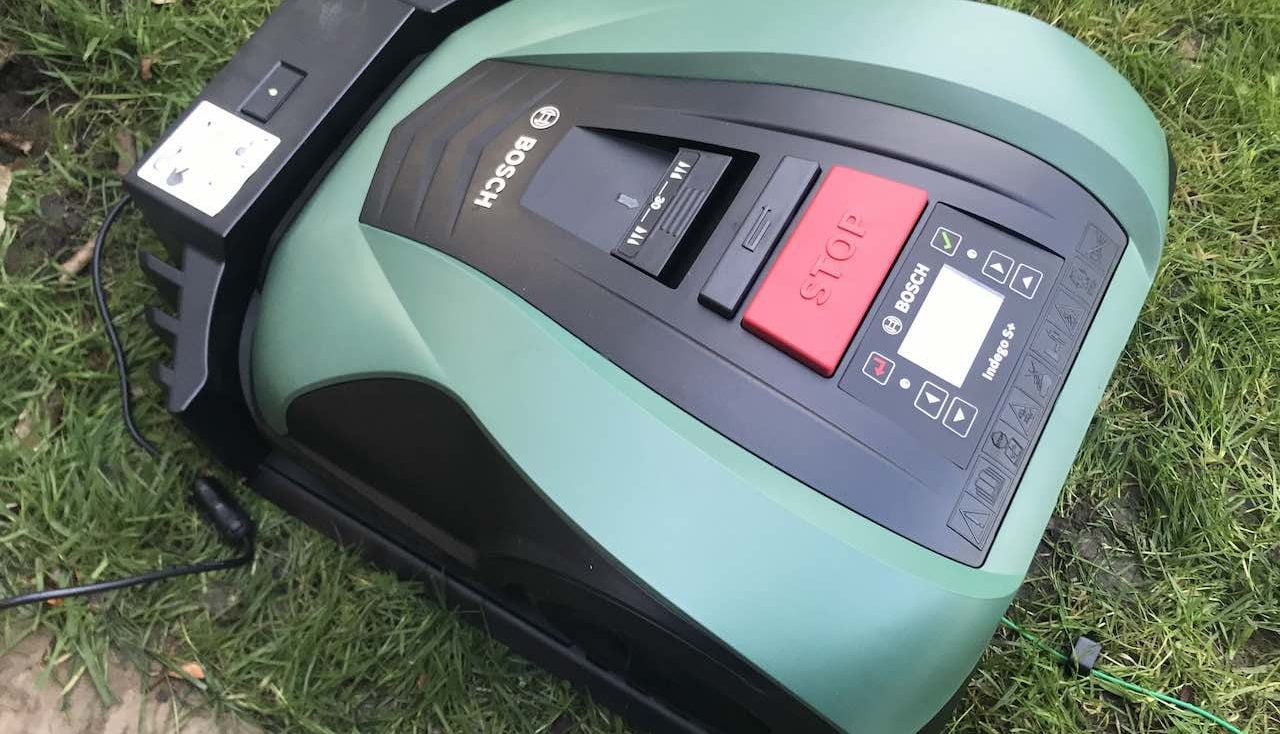 Green BOSCH robot mower on grass