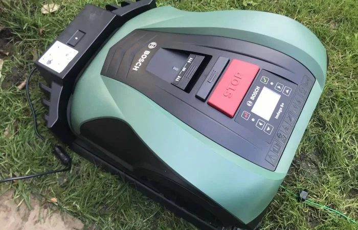 Green BOSCH robot mower on grass
