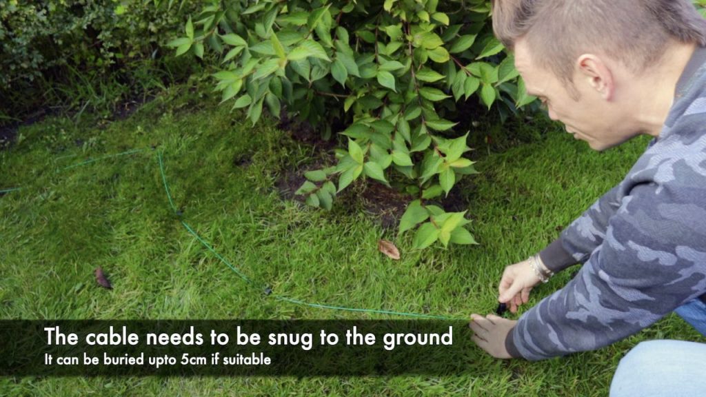 Garden Ninja fitting a wire for a robotic lawn mower