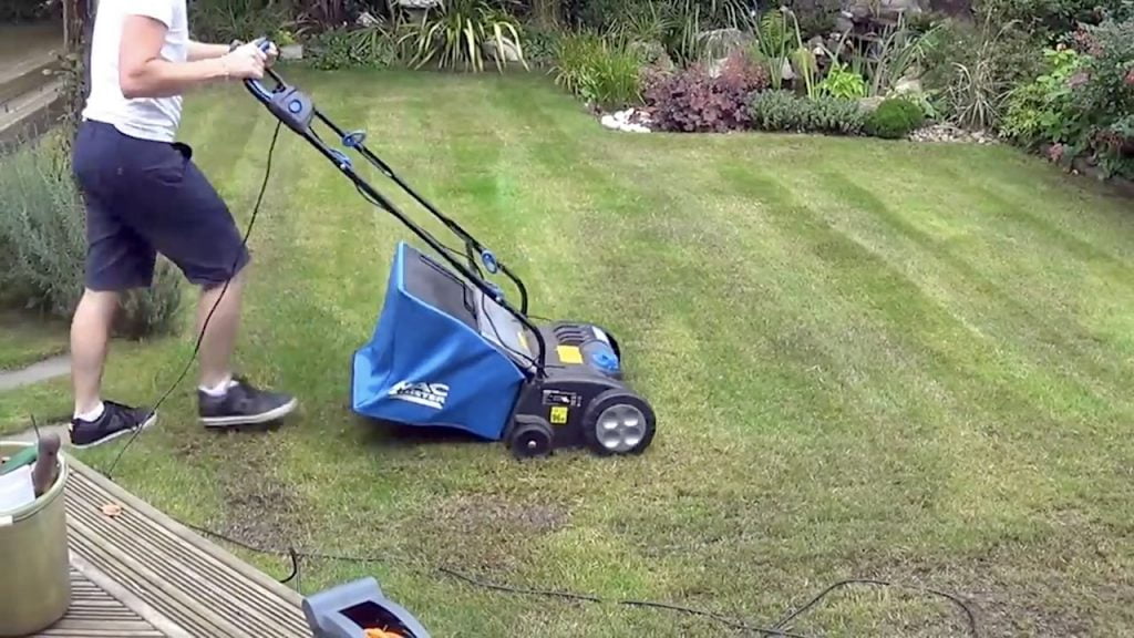 Scarifying a lawn with a powered scarifier