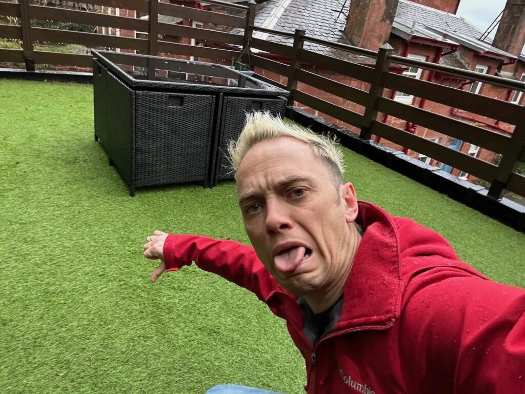 Lee Burkhill gurning at horrible artificial grass