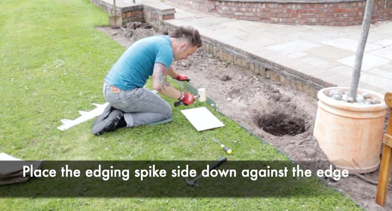 Hammering metal lawn edging into position