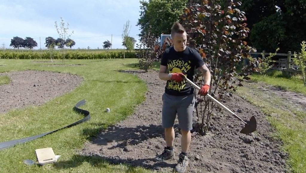 Lee Burkhill edging a lawn in the exploding atom garden