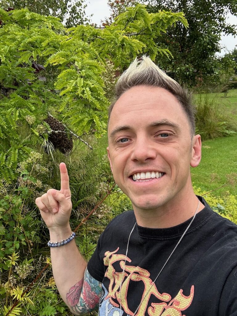 Lee Burkhill with a swarm of bees
