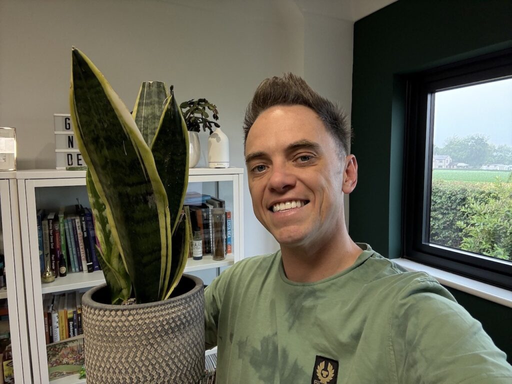 Lee Burkhill holding a snake plant