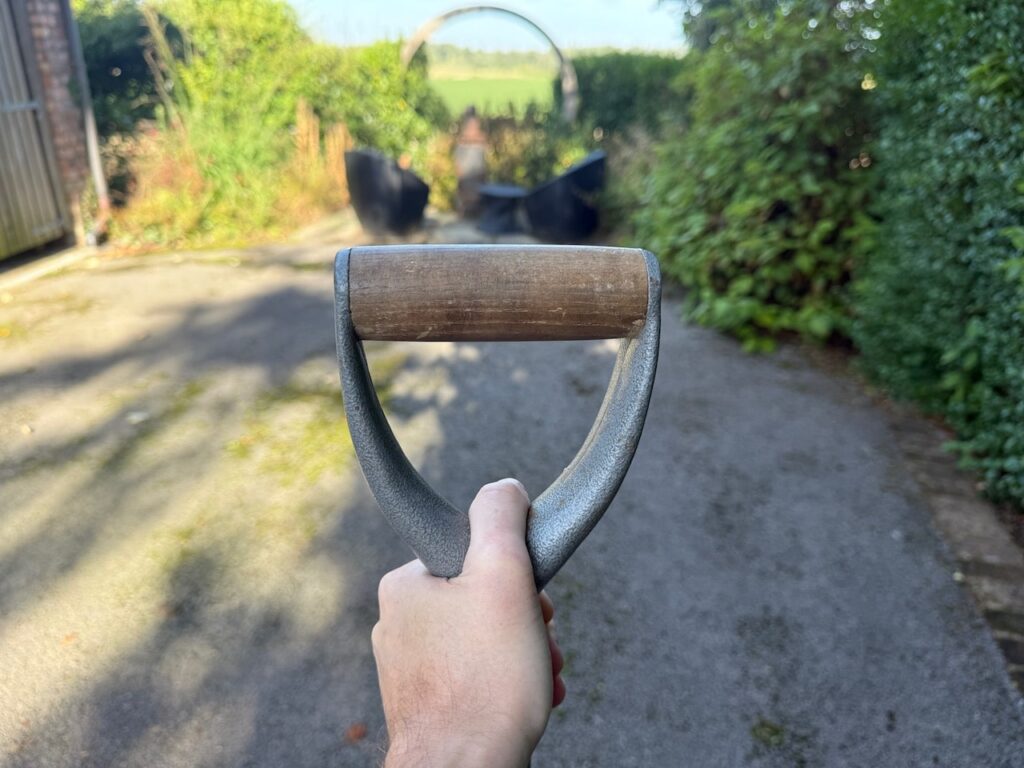 A wooden handled spade