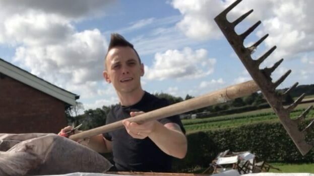 Garden Blogger Lee Burkhill Holding a rake