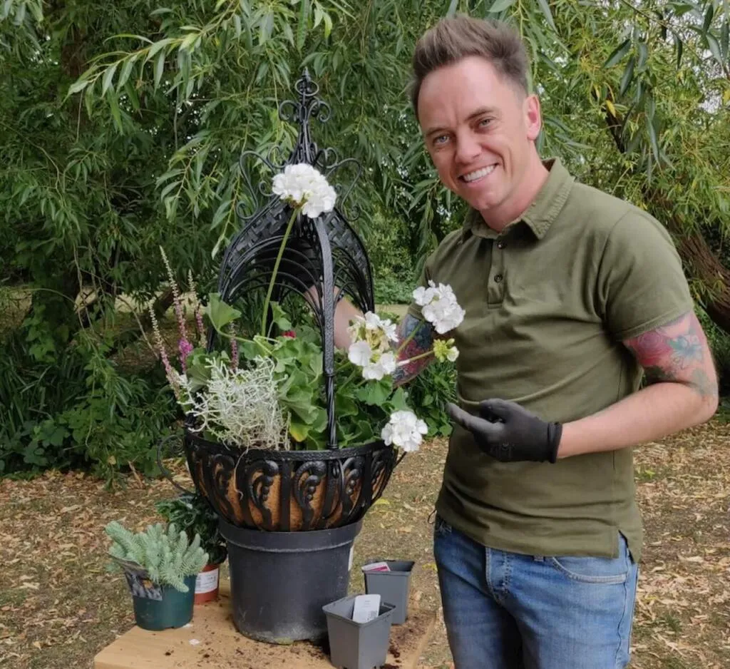 Lee Burkhill planting hanging baskets