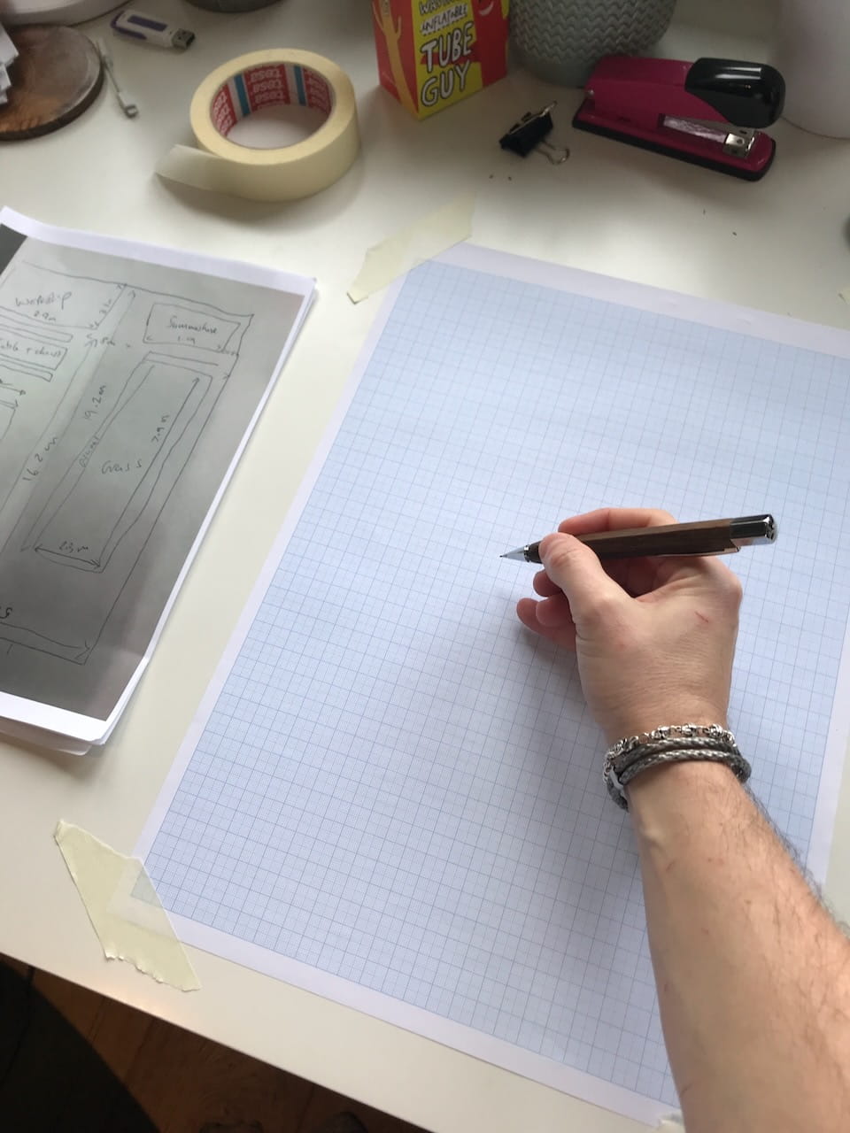 Using graph paper and a scale ruler to lay out a garden design plan